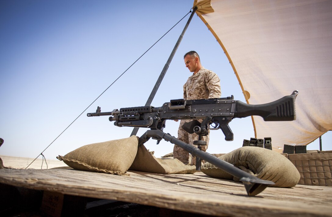 U.S. Marine Corps Sgt. Philip Noble with Headquarters Company, Regimental Combat Team 7, sets up an M240B machine gun before conducting a familiarization shoot on Camp Leatherneck, Helmand province, Afghanistan, May 12, 2013. The range was conducted to familiarize the shooters on the proper employment of the respective weapons systems. (U.S. Marine Corps photo by Staff Sgt. Ezekiel R. Kitandwe/Released)