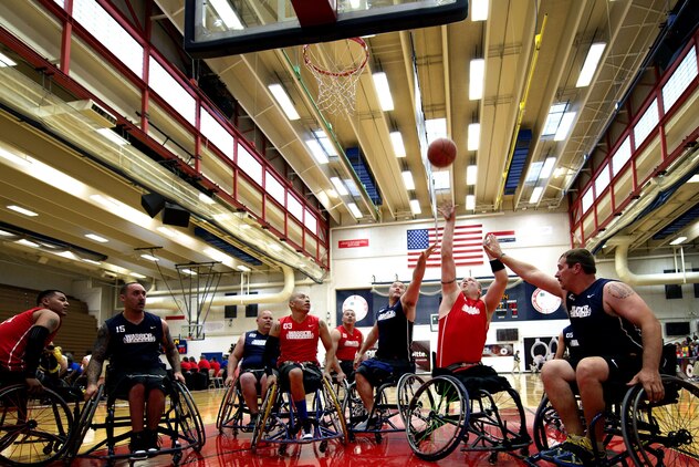Marine and Navy wheelchair basketball players fight for a rebound during the first round of the wheelchair basketball tournament at the 2013 Warrior Games here May 12. From May 11-16, more than 200 wounded, ill and injured service members and veterans from the U.S. Marines, Army, Air Force and Navy, as well as a team representing U.S. Special Operations Command and an international team representing the United Kingdom, will compete for the gold in track and field, shooting, swimming, cycling, archery, wheelchair basketball and sitting volleyball at the U.S. Olympic Training Center and U.S. Air Force Academy here. The military service with the most medals will win the Chairman's Cup. 
