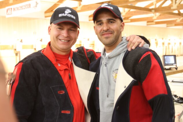 Marine veterans Gunnery Sgt. Pedro Aquino and Cpl. Angel Gomez, congratulate one another after tying for a gold medal during an air rifle shooting competition at the 2013 Warrior Games aboard the U.S. Olympic Training Center in Colorado Springs, Colo., May 13.