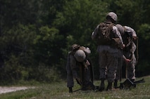Marines with Headquarters and Service Company, 2nd Maintenance Battalion, 2nd Marine Logistics Group load .50-caliber M2 machine gun rounds into ammunition cans during a field exercise aboard Camp Lejeune, N.C., May 9, 2013. Approximately 20 Marines with the company trained with M2 machine guns under the instruction of machine gunners with 2nd Battalion, 9th Marine Regiment, 2nd Marine Division.