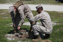 Marines with Headquarters and Service Company, 2nd Maintenance Battalion, 2nd Marine Logistics Group fill a sandbag during the company’s field exercise held aboard Camp Lejeune, N.C., May 9, 2013. The Marines used sandbags as weights to hold .50-caliber M2 machine guns in position during live fire.