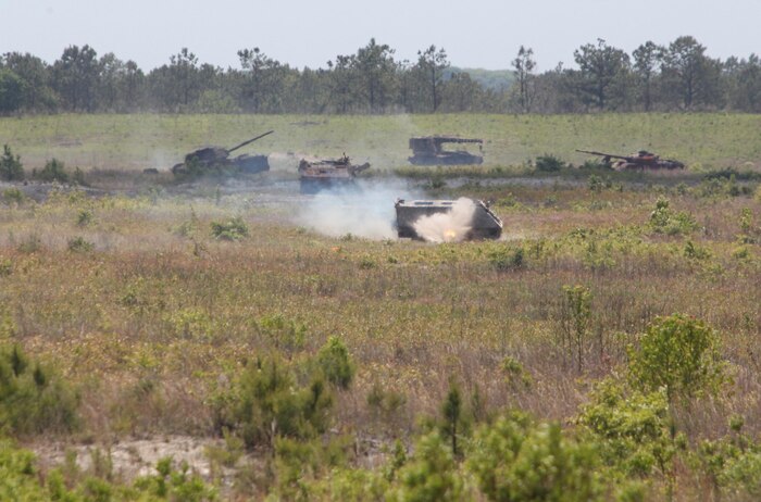 An obsolete armored personnel carrier takes fire from Marines with Headquarters and Service Company, 2nd Maintenance Battalion, 2nd Marine Logistics Group at a machine gun range during a field exercise held by the company aboard Camp Lejeune, N.C., May 9, 2013. The Marines used .50-caliber M2 machine guns to practice loading, aiming and firing procedures against vehicles at ranges of several hundred yards.