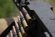 Armor-piercing rounds enter the firing chamber of a .50-caliber M2 machine gun, which belongs to Headquarters and Service Company, 2nd Maintenance Battalion, 2nd Marine Logistics Group during a field exercise aboard Camp Lejeune, N.C., May 9, 2013. Approximately 20 servicemembers with the company used the M2s as part of a four-day training operation in order to maintain combat readiness within the unit. 
