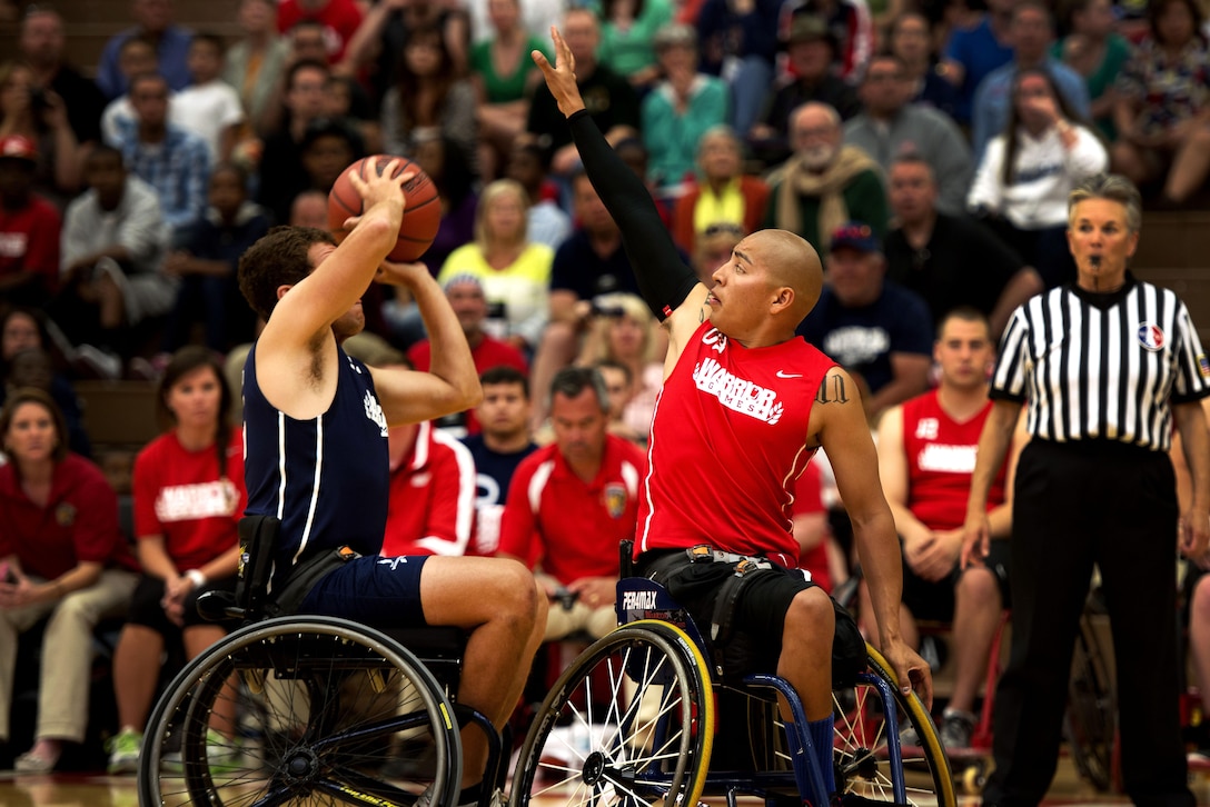 Josue Barron attempts to block a Navy players pass during the first round of the basketball tournament at the 2013 Warrior Games here May 12. The Marines won 53-17. In October 2010, Barron, a native of Cudahy, Calif., was deployed with 3/5, the Darkhorse Battalion. During the deployment, Darkhorse lost 24 men, more than any other Marine unit in Afghanistan in support of operations there. During a patrol, Barron's friend stepped on an improvised explosive device and lost both his legs and a few of his fingers. Barron lost his left leg and left eye. He considers himself lucky. From May 11-16, more than 200 wounded, ill and injured service members and veterans from the U.S. Marines, Army, Air Force and Navy, as well as a team representing U.S. Special Operations Command and an international team representing the United Kingdom, will compete for the gold in track and field, shooting, swimming, cycling, archery, wheelchair basketball and sitting volleyball at the U.S. Olympic Training Center and U.S. Air Force Academy here. The military service with the most medals will win the Chairman's Cup. (U.S. Marine Corps photo by Sgt. Tyler L. Main/Released)