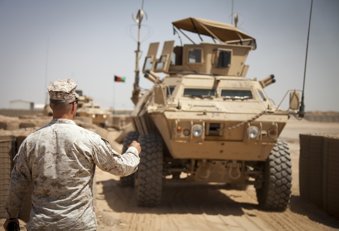 U.S. Marine Corps Staff Sgt. Mark Oeser from Brenham, Texas, and assigned to the  Mobile Strike Force Advisor Team, observes as a Mobile Strike Force Vehicle assigned to the Afghan National Army (ANA) Mobile Strike Force Kandak, navigates through a series of obstacles at a rough terrain driving course on Camp Bastion, Helmand province, Afghanistan, May 13, 2013. The course was part of a three day training package that the Marines with Mobile Strike Force Advisor Team conducted for their ANA counterparts. (U.S. Marine Corps photo by Staff Sgt. Ezekiel R. Kitandwe/Released)
