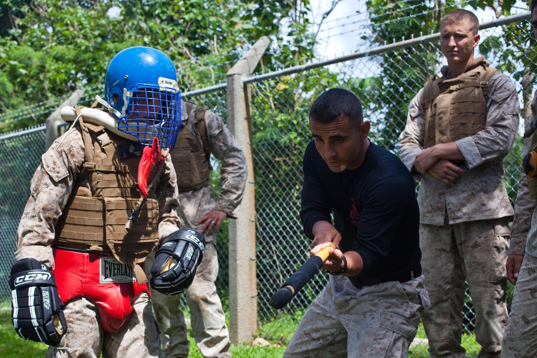 Captain Tyson Scott (center), officer in charge of the Martial Arts Instructor Course led by the 31st Marine Expeditionary Unit and an instructor trainer, demonstrates proper strikes with a fixed bayonet during an integrated weapons sparring exercise here, May 14. The students participating in the course learned how to instruct Marines in every aspect of the Marine Corps Martial Arts Program, earning the tan tab of an instructor upon completion. The 31st MEU is the only continuously forward-deployed MEU and is the Marine Corps’ force in readiness in the Asia-Pacific region.