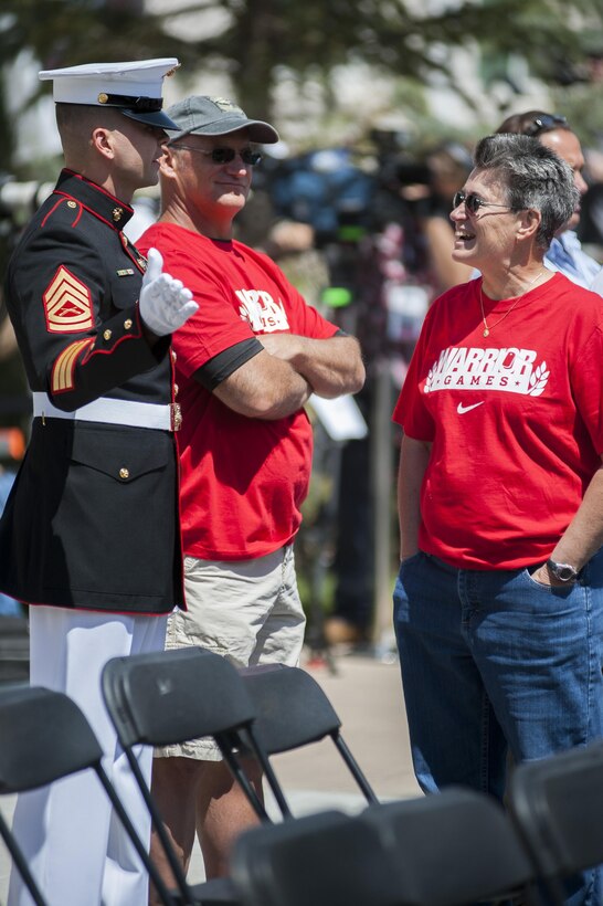 Gunnery Sgt. Bradley Chrisman, a ceremonial hoster from Marine Barracks Washington, D.C., talks to guests at the opening ceremony of the Wounded Warrior Games 2013 in Colorado Springs, Colo., May 11. Approximately 80 Marines from the Barracks participated in the ceremony.