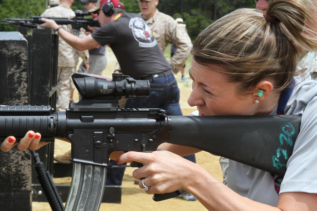 Rachel Knapschaefer, a counselor with the Linden-McKinley STEM Academy in Hilliard, Ohio, fires an M16 A-4 Service Rifle as a part of the 2013 Educator Workshop, May 1.