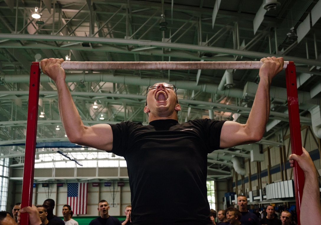 Poolees from Marine Corps Recruiting Station Baltimore shout encouragement to other poolees as they do pullups during RS Baltimore's statewide pool function at the United States Naval Academy, May 11.