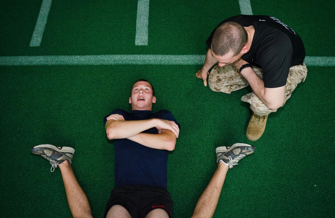 A poolee from Marine Corps Recruiting Station Baltimore performs crunches during RS Baltimore's statewide pool function at the United States Naval Academy, May 11.