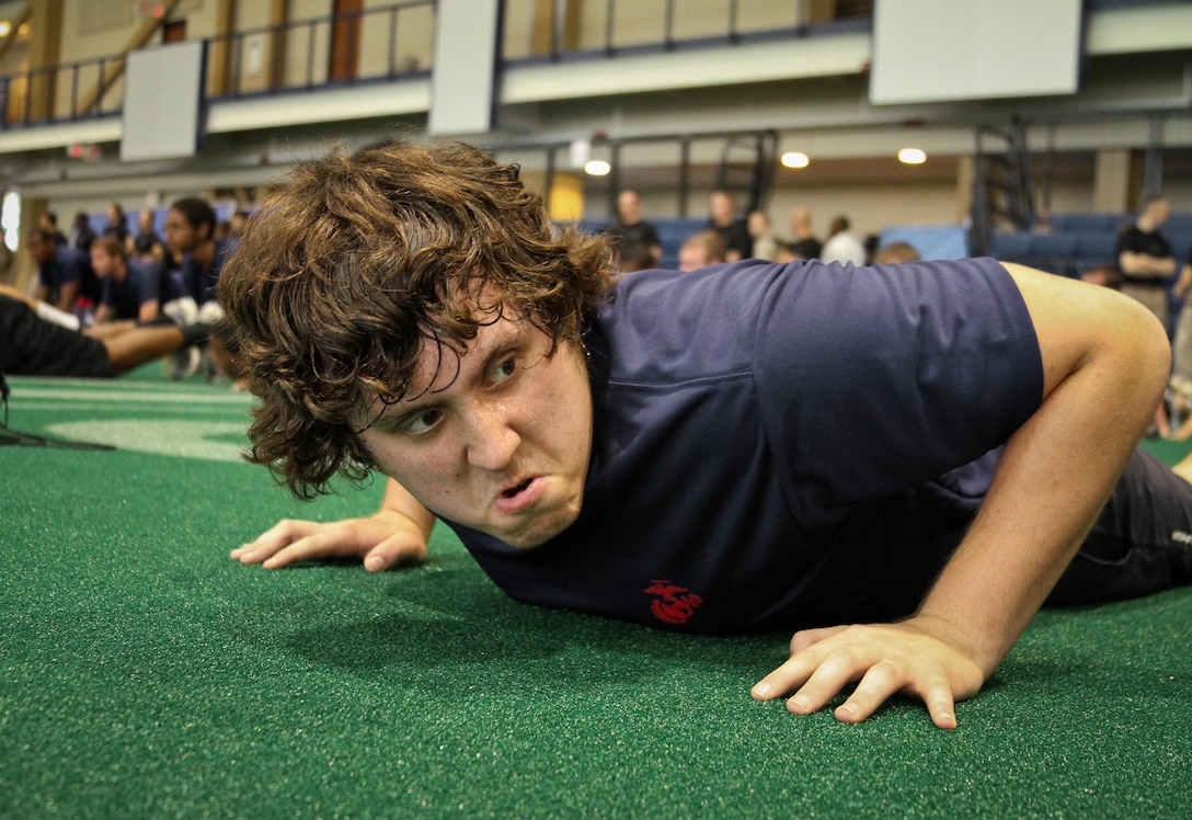 A poolee from Marine Corps Recruiting Station Baltimore prepares to do pushups during RS Baltimore’s statewide pool function at the United States Naval Academy, May 11. 