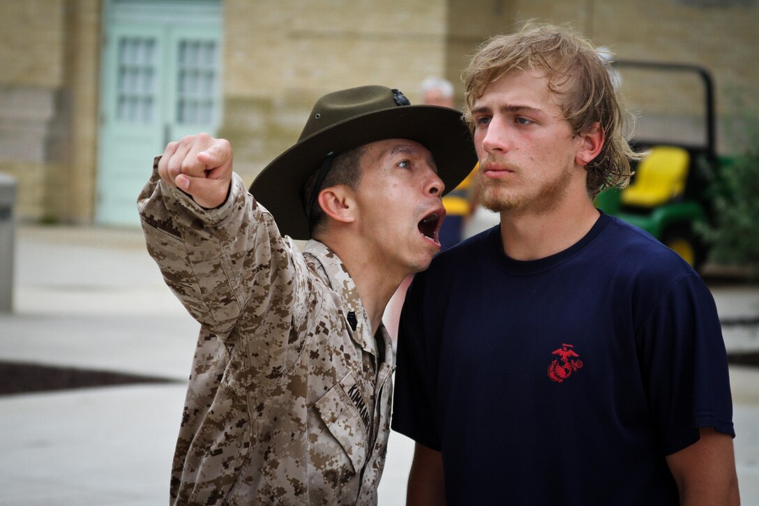 Gunnery Sgt. Tony S. Kimmanee, a drill instructor at the United States Naval Academy, gives instruction to a poolee from Marine Corps Recruiting Station Baltimore during their statewide pool function at the USNA, May 11.