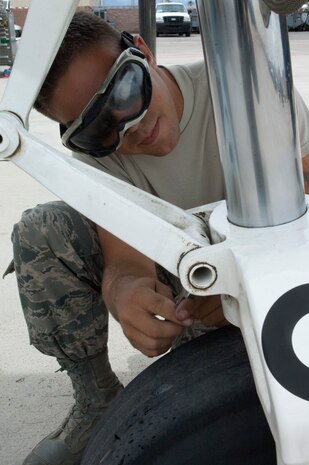 Staff Sgt. Joshua Drought, 757th Aircraft Maintenance Squadron A-10 Thunderbolt II crew chief, services the struts of an A-10 Thunderbolt II May 9, 2013, at Nellis Air Force Base, Nev. The A-10 began service with the Air Force in 1975 and has remained effective in air to ground combat operations through constant maintenance and continued technological upgrades. (U.S. Air Force photo by Airman 1st Class Joshua Kleinholz)