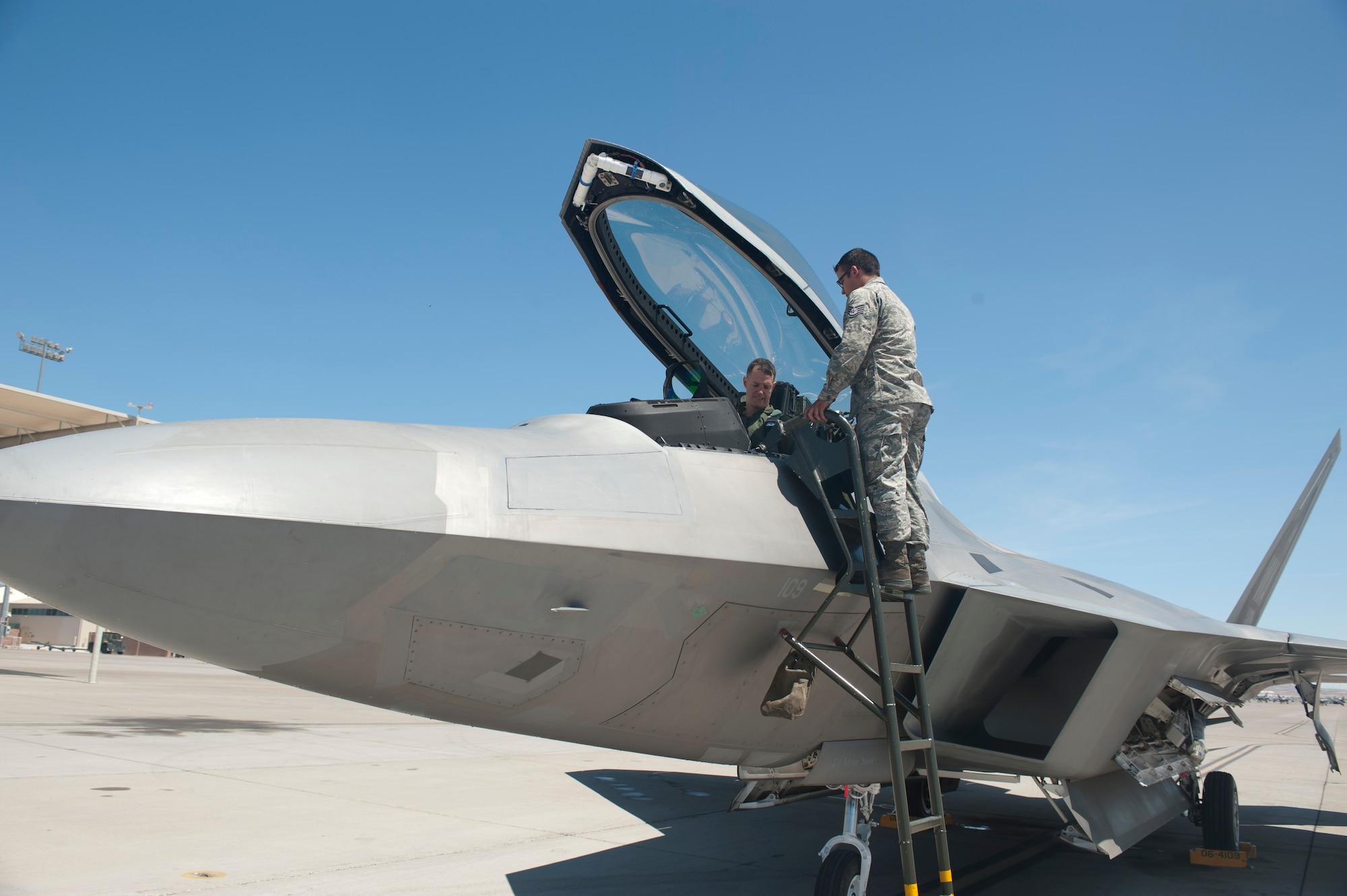 Senior Airman Juan Vela, 57th Aircraft Maintenance Squadron crew chief, congratulates Col. Alex Grynkewich, 57th Wing vice commander, at the conclusion of his “fini-flight” May 10, 2013, at Nellis Air Force Base, Nev. Following the flight Airmen from the 57th WG thanked Grynkewich for the job he’d done serving as their vice commander. (U.S. Air Force photo by Staff Sgt. Michael Charles) 