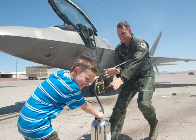 Justin Grynkewich sprays his father, Col. Alex Grynkewich, 57th Wing vice commander, with an extinguisher after his “fini” flight May 10, 2013, at Nellis Air Force Base, Nev. Grynkewich served as the wing’s vice commander for a year before being chosen for a wing command position at the 53rd Wing at Eglin Air Force Base, Fla. (U.S. Air Force photo by Staff Sgt. Michael Charles) 