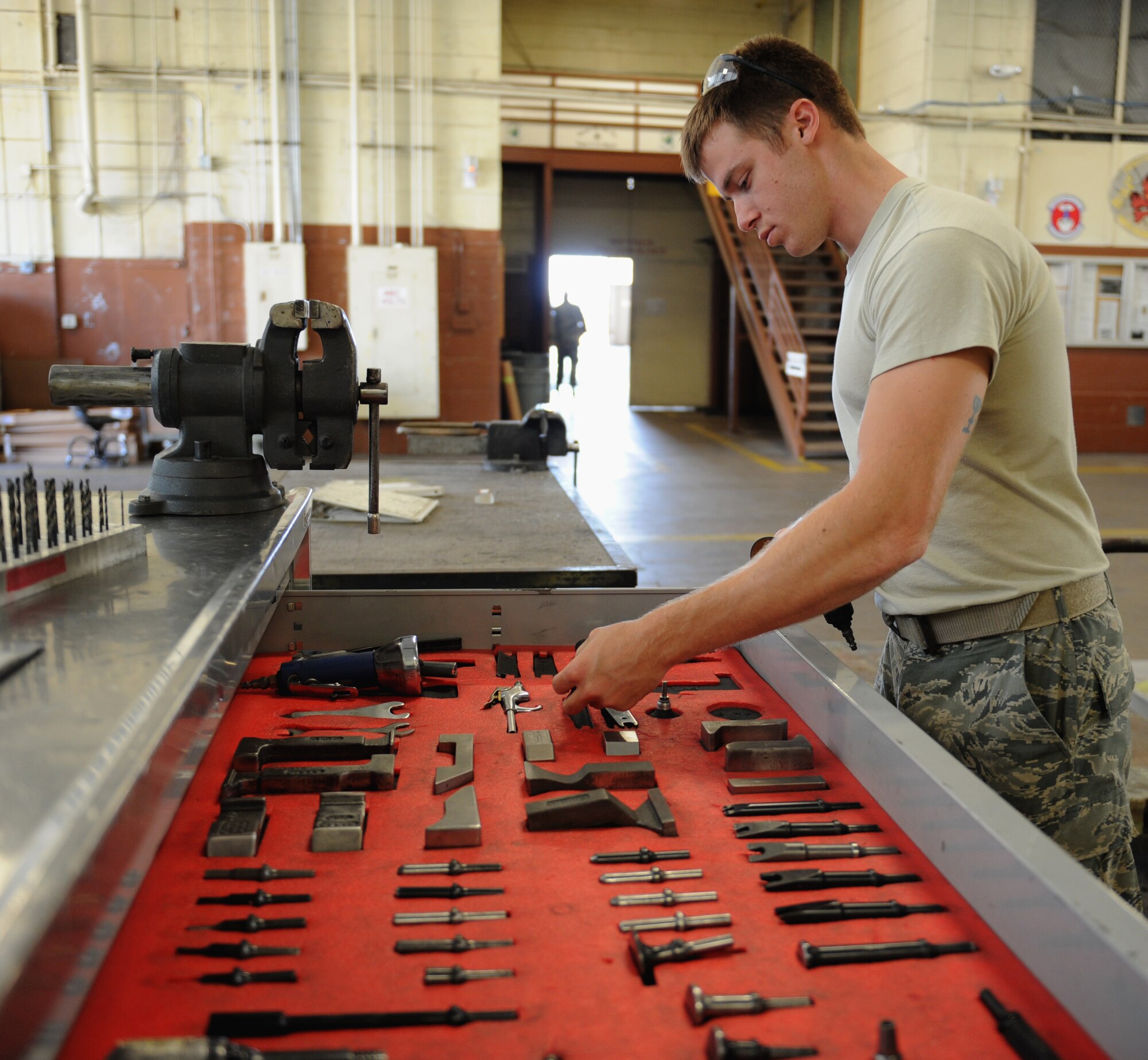 Staff Sgt. Cameron Elvin, 2nd Maintenance Squadron Fabrication Flight sheet metal, looks for a tool on Barksdale Air Force Base, La., May 14, 2013. Airmen from the fabrication flight repair or replace sheet metal and fix loose rivets and cracks on the B-52H Stratofortress. (U.S. Air Force photo/Airman 1st Class Benjamin Gonsier) 
