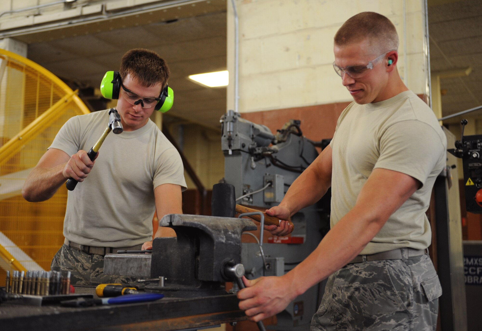 Staff Sgt. Cameron Elvin and Senior Airman Hayden Johnson, 2nd Maintenance Squadron Fabrication Flight sheet metal, create metal parts on Barksdale Air Force Base, La., May 14, 2013. Airmen from the fabrication flight repair or replace sheet metal and fix loose rivets and cracks on the B-52H Stratofortress. (U.S. Air Force photo/Airman 1st Class Benjamin Gonsier)
