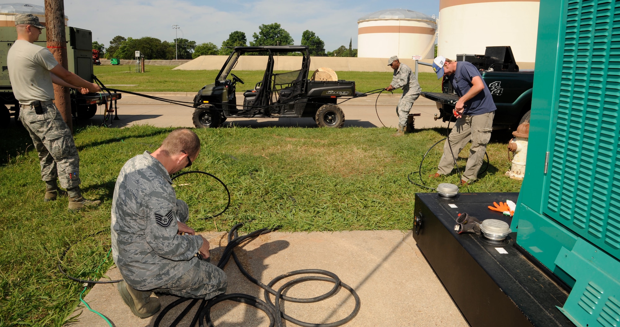 Airmen from the 2nd Civil Engineer Squadron prepare to install cabling to a generator on Barksdale Air Force Base, La., May 14, 2013. Power production's responsibilities include maintaining backup generators and power facilities throughout Barksdale. (U.S. Air Force photo/Airman 1st Class Andrew Moua)