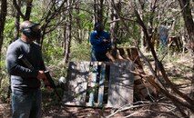 Three airmen post to defend their flag during a Warrior Care retreat in New Braunfels, Texas, May 4, 2013. Airmen attending the retreat participated in paintball, high-rope challenges and resiliency training. The Chapel retreats are open for all airmen. (U.S. Air Force photo/Airman 1st Class Jimmie D. Pike)