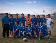 Sutton Dalrymple, daughter of a Laughlin active duty member, poses with San Felipe Del Rio Soccer Club boys under 14 team before practice at a Del Rio High School practice field on May 8.  Dalrymple will be competing in Houston, Texas, May 11-12 in the South Texas Cup for a chance to progress to the U.S. Youth Soccer National Championships. (U.S. Air Force photo/2nd Lt. Lyle T. Ratcliffe)