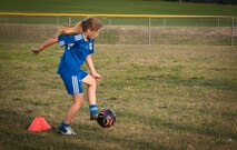 Sutton Dalrymple, daughter of a Laughlin active duty member, poses with San Felipe Del Rio Soccer Club boys under 14 team before practice at a Del Rio High School practice field on May 8.  Dalrymple will be competing in Houston, Texas, May 11-12 in the South Texas Cup for a chance to progress to the U.S. Youth Soccer National Championships. (U.S. Air Force photo/2nd Lt. Lyle T. Ratcliffe)