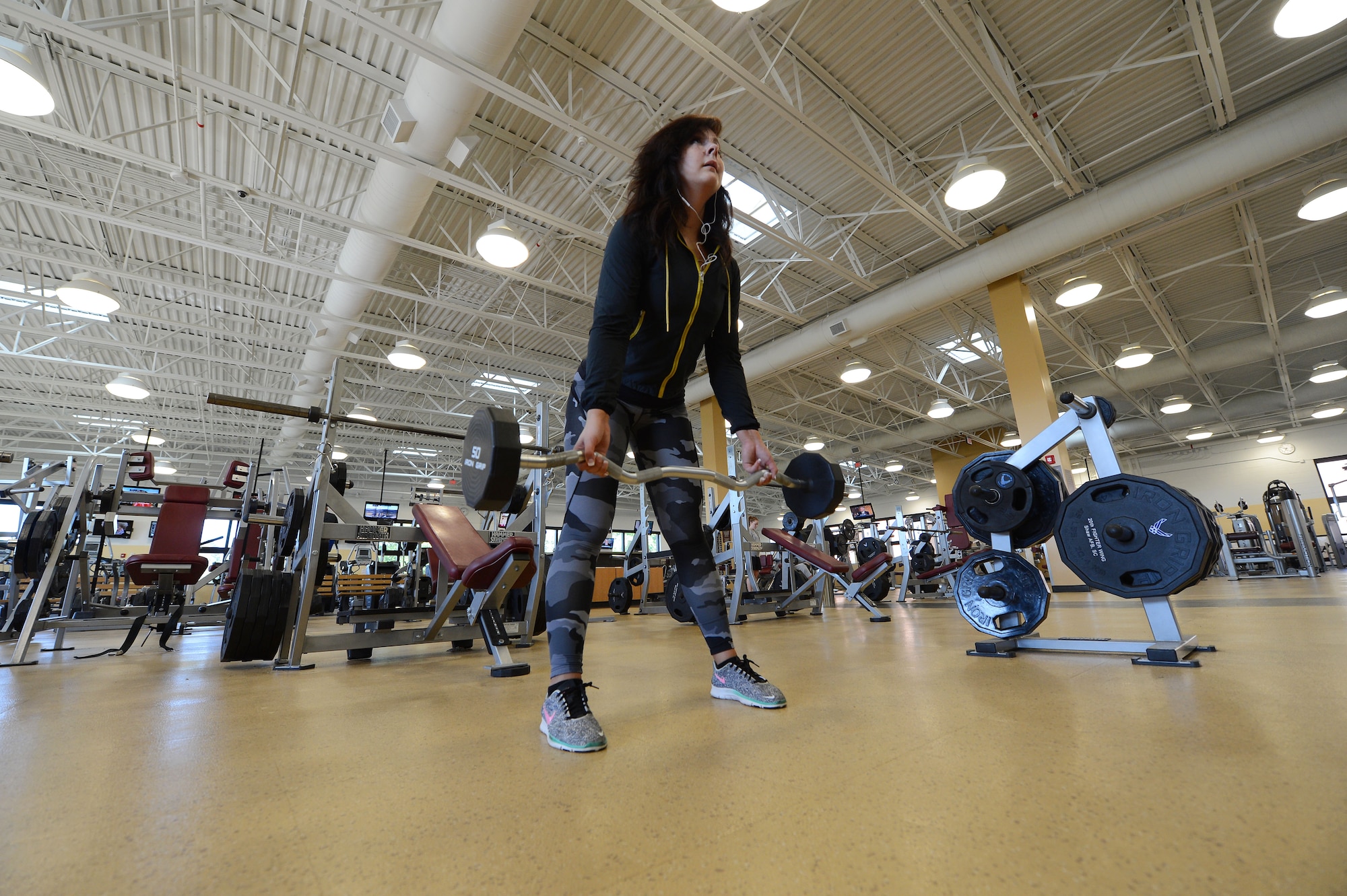 Rachell Davis, retired U.S. Air Force weather meteorologist, National Physique Committee bikini competitor and power lifter and lifestyle coach rows a barbell at the Fitness Center, Shaw Air Force Base, S.C., May 13, 2013.  Davis has competed three times in the past two years in physique competitions and three times in power lifting competitions. (U.S. Air Force photo by Airman 1st Class Nicole Sikorski/Released)