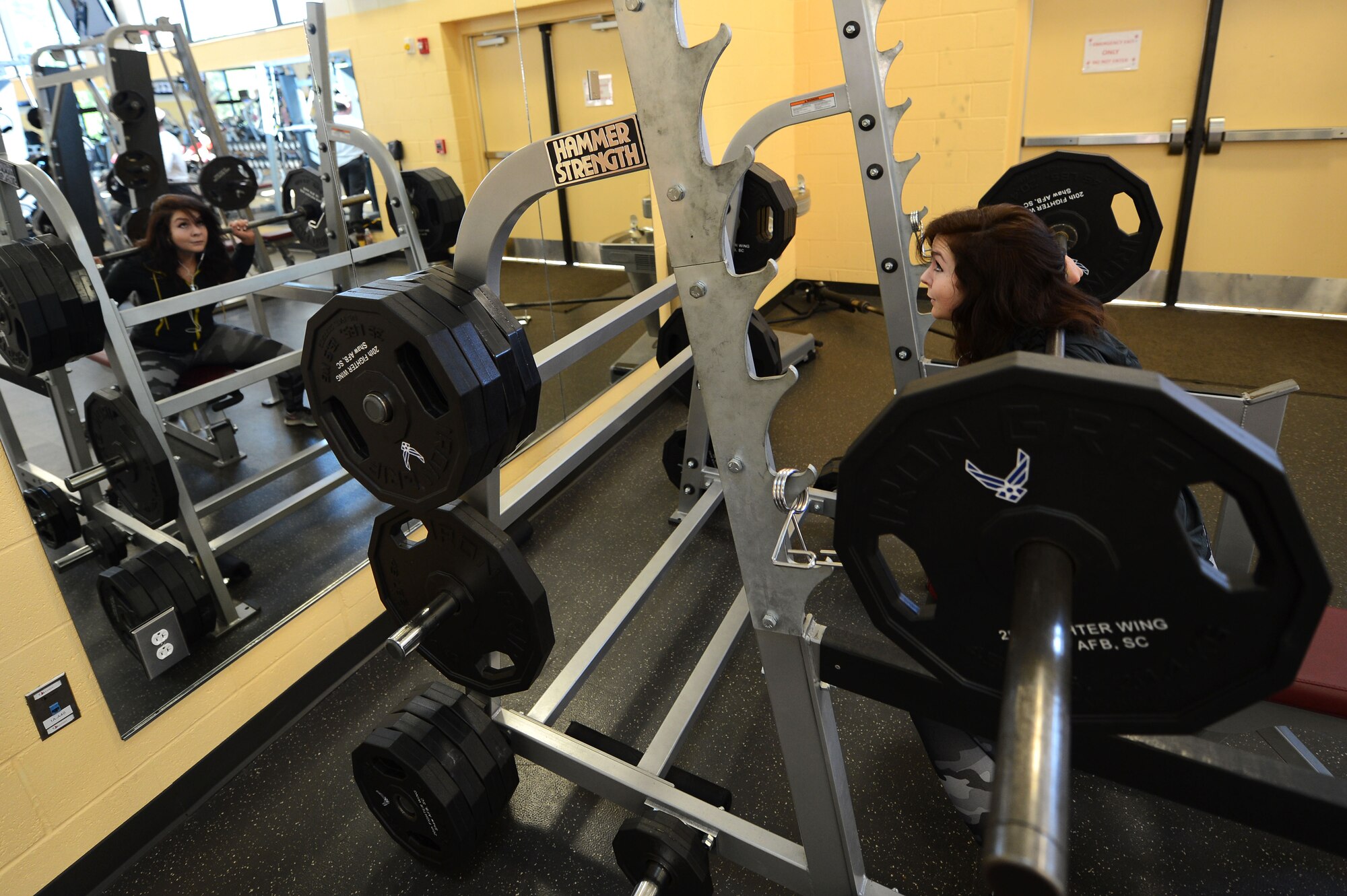 Rachell Davis, retired U.S. Air Force weather meteorologist, National Physique Committee bikini competitor and power lifter and lifestyle coach squats at the Fitness Center, Shaw Air Force Base, S.C., May 13, 2013.  Davis has competed three times in the past two years in physique competitions and three times in power lifting competitions.  (U.S. Air Force photo by Airman 1st Class Nicole Sikorski/Released)


