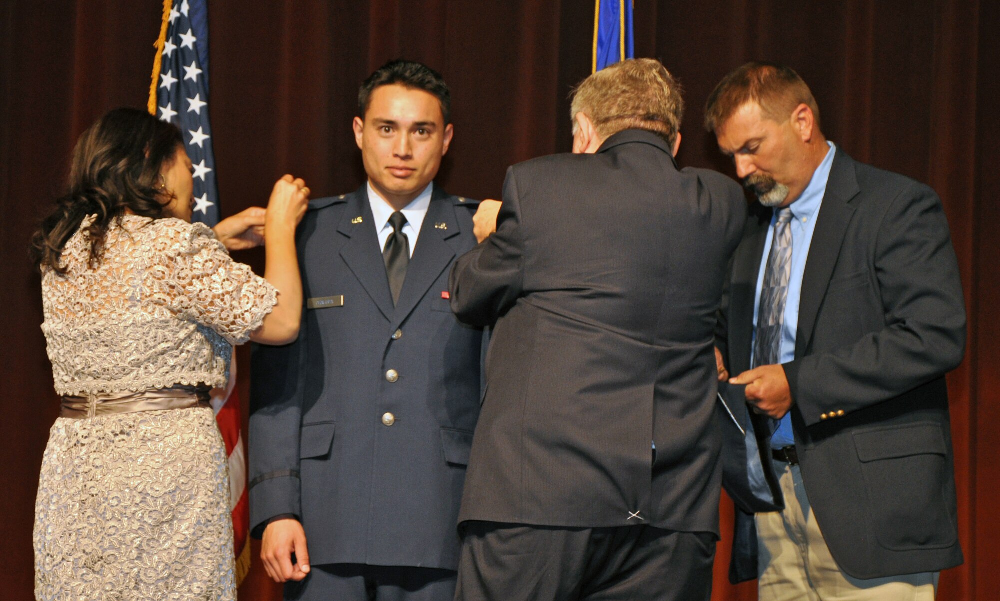 SAN ANGELO, Texas - 2nd Lt. Kenneth Chalupa, former Angelo State University Air Force ROTC Detachment 847 cadet, receives his second lieutenant bars during a ROTC commissioning ceremony at ASU Houston Harte University Center here, May 10. Chalupa chose to have his mother, stepfather and grandfather pin on his rank. (U.S. Air Force photo/ Airman 1st Class Joshua Edwards)