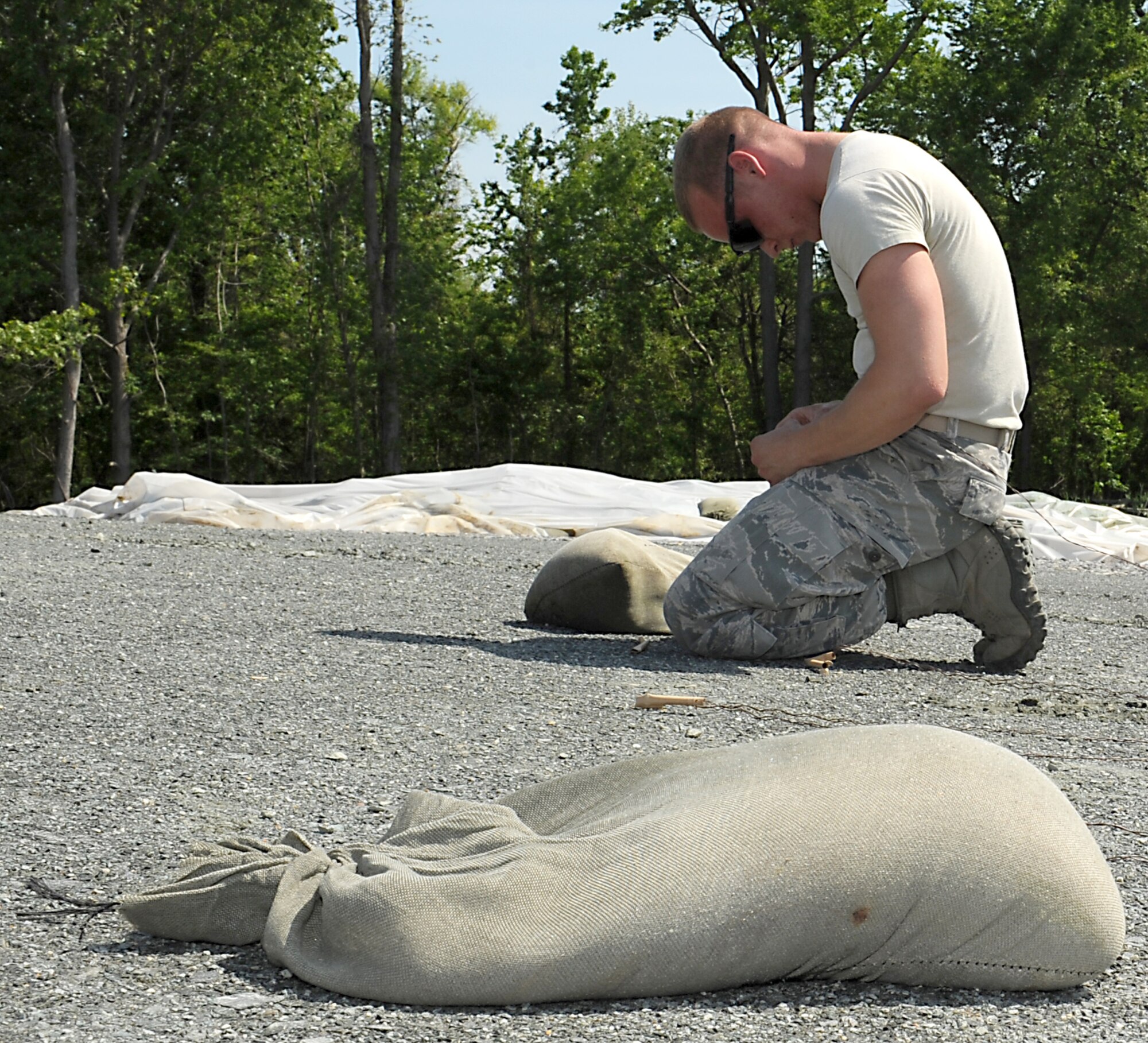 U.S. Air Force Airman 1st Class Brandon Foster, 633rd Civil Engineer Squadron explosive ordnance disposal technician, prepares to ignite more than one pound of Composition C-4 plastic explosives at the new EOD range on Langley Air Force Base Va., May 10, 2013. The four-acre range is located at the northernmost edge of the installation. (U.S Air Force photo by Airman 1st Class Kimberly Nagle/Released)