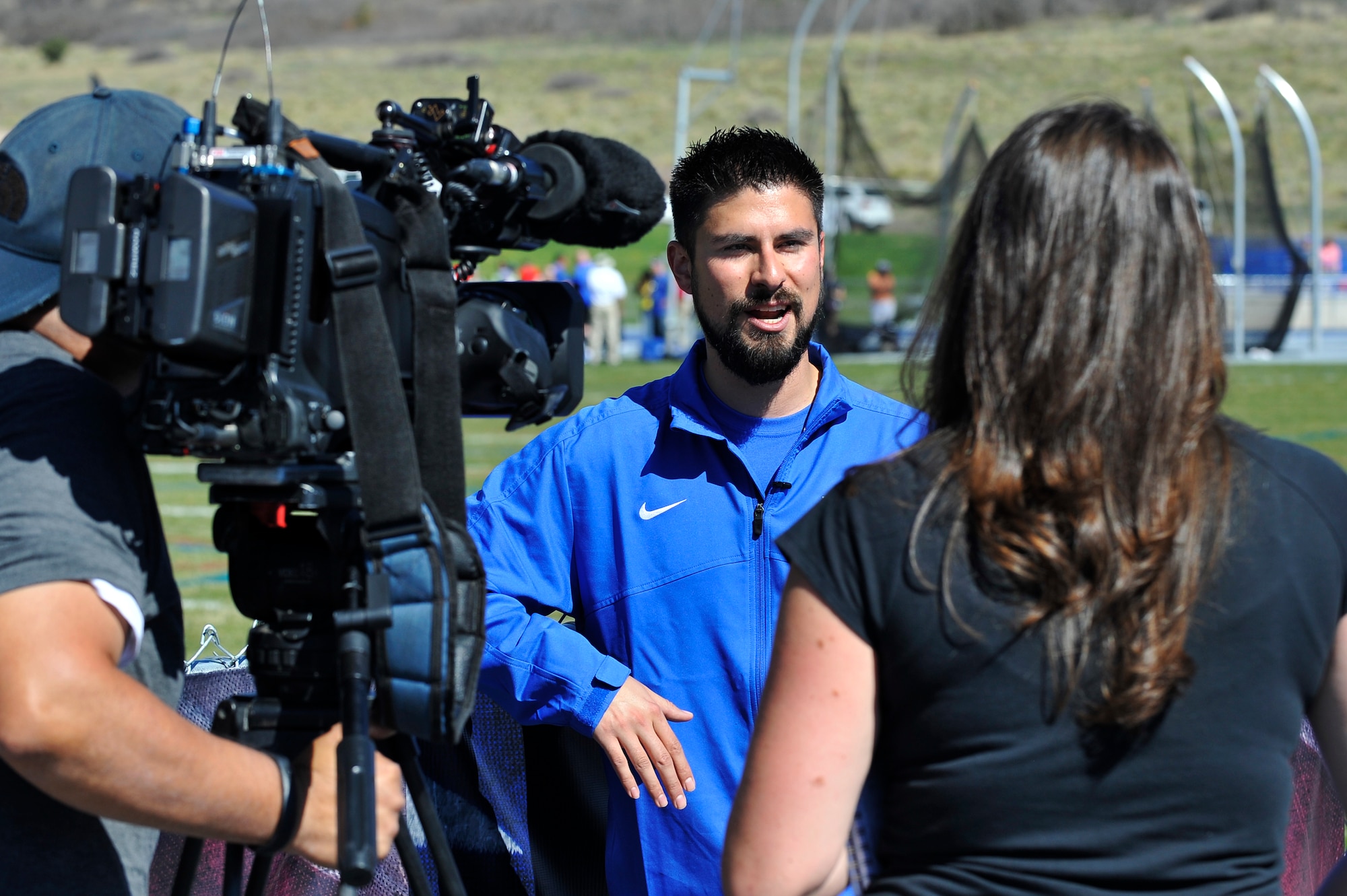A CNN news team interviews prior Air Force Senior Airman Stephen Otero during the 2013 Warrior Games at the U.S. Air Force Academy May 14, Colorado Springs, Colo. Otero described how being able to compete in the games has changed his outlook on life and restored his sense of balance. (U.S. Air Force photo by Staff Sgt. Christopher Boitz/Released)