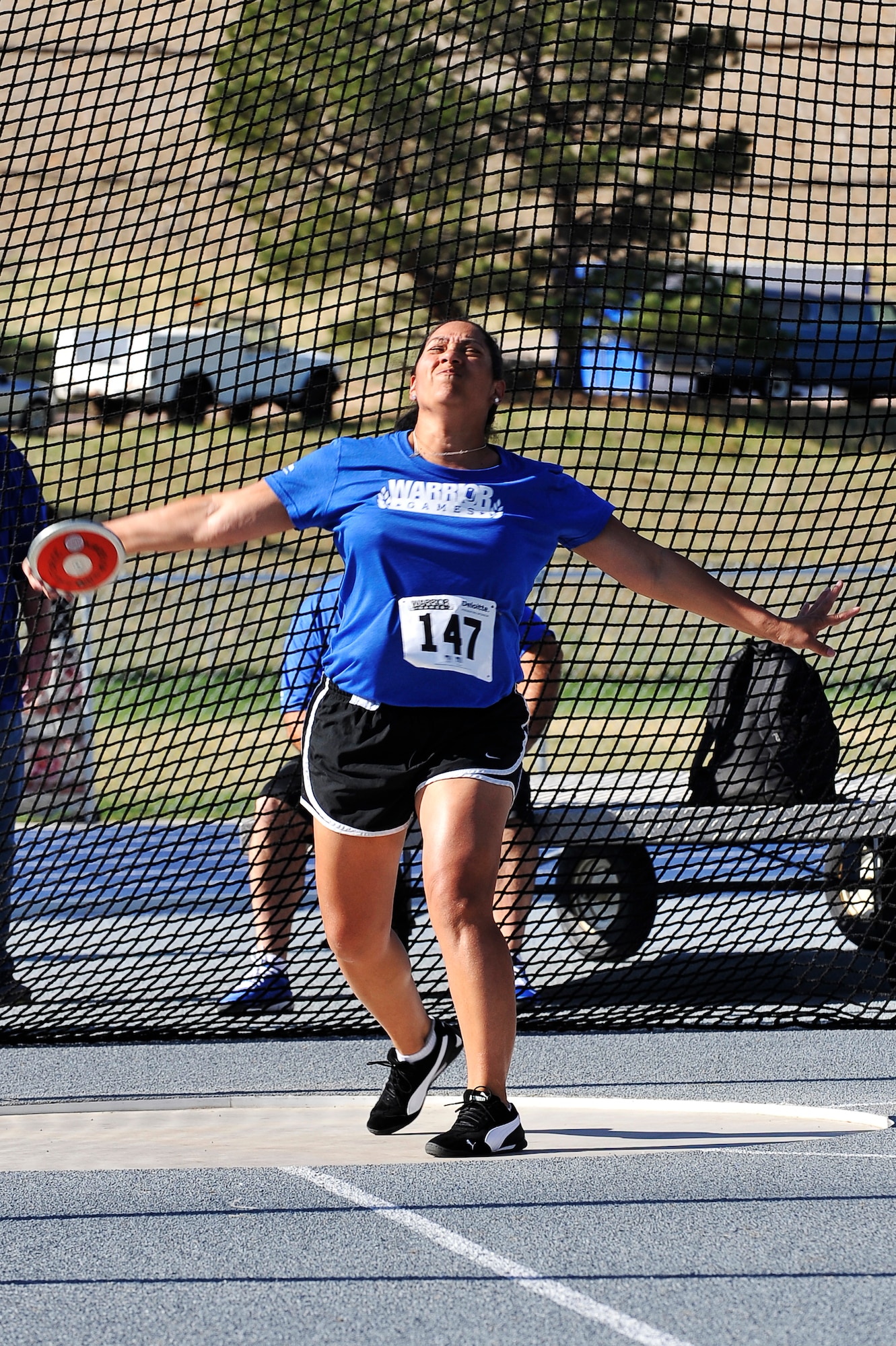 Tech Sergeant Monica Figueroa throws a discus during the 2013 Warrior Games at the U.S. Air Force Academy May 14, Colorado Springs, Colo. The Warrior Games enable service members and veterans who are injured or ill to compete in a variety of Paralympic sports. Figueroa is breast cancer survivor. (U.S. Air Force photo by Staff Sgt. Christopher Boitz/Released)