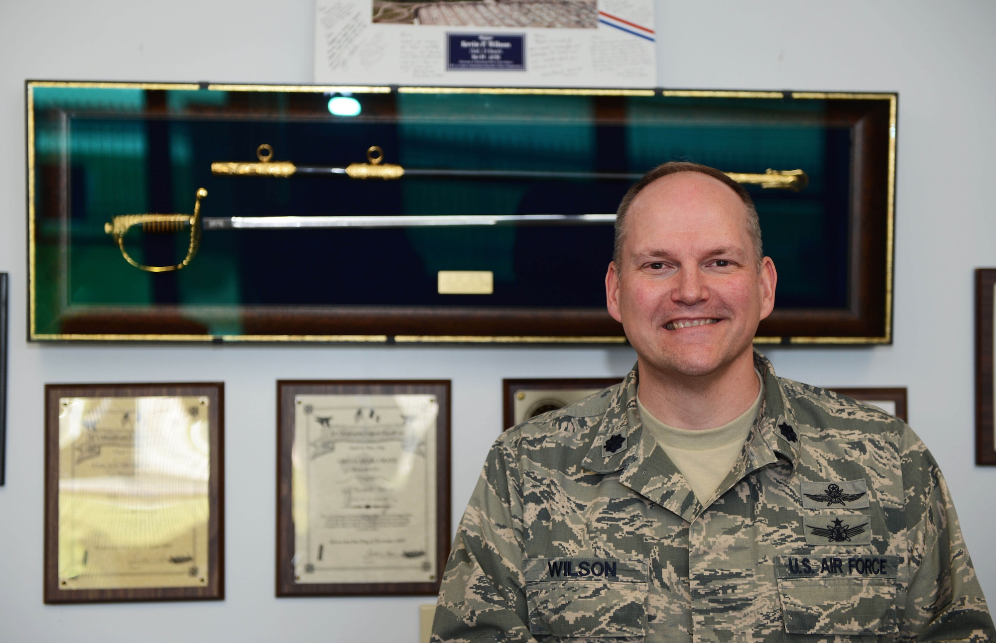 Lt. Col. Kevin Wilson, 20th Communications Squadron commander, stands at his desk at Shaw Air Force Base, S.C., April 22, 2013. The communications squadron responsibilities range from navigating jets safely to the ground to making sure Shaw’s computer network stays up and running. (U.S. Air Force photo by Airman 1st Class Daniel Blackwell/Released)