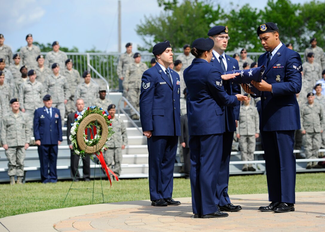 Security Forces members fold the flag during Joint Base Andrews’ National Police Week Formal Retreat Ceremony on May 13, 2013. In 1962, President John F. Kennedy signed a proclamation designating May 15 as Peace Officers Memorial Day and the week in which that date falls as Police Week. (U.S. Air Force photo/Airman 1st Class Nesha Humes)