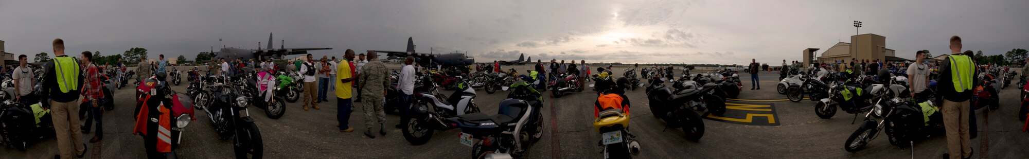 Riders mingle during a Motorcycle Safety Rally on the flight line on Hulrburt Field, Fla., May 10, 2013. Active-duty, retired and DOD cardholders came out to attend the event, which included a brief on safety and use of proper personal protective equipment and an obstacle course ride demo by skilled riders from local law enforcment.
(U.S. Air Force Photo illustration/ Staff Sgt. John Bainter)	

