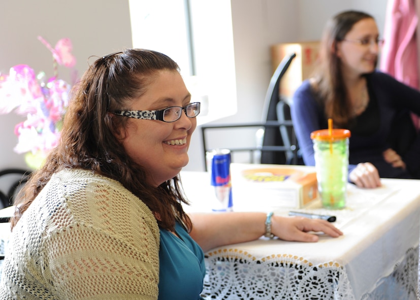 Angila Compton, 23d Force Support Squadron Airman’s Attic manager, sits amongst  volunteers in the Airman’s Attic entrance at Moody Air Force Base, Ga., May 7, 2013. Compton started working with the Airman’s Attic program at Holloman Air Force Base, N.M., in 1991, and now manages the one here. (U.S. Air Force photo by Senior Airman Eileen Meier/Released)