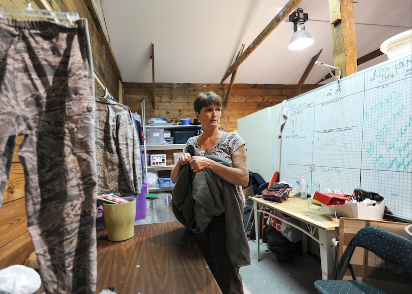 A volunteer spouse sorts through donations in the back room of the Airman’s Attic at Moody Air Force Base, Ga., May 7, 2013. Volunteers are always needed for the Airman’s Attic program, which offers donated household goods and uniforms at no charge to Airmen E-5 and below and their families. (U.S. Air Force photo by Senior Airman Eileen Meier/Released)
