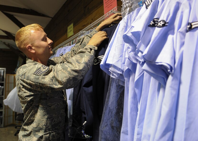 U.S. Air Force Staff Sgt. Christopher Horton, 23d Maintenance Group quality assurance inspector, hangs up uniforms donated to the Airman’s Attic at Moody Air Force Base, Ga., May 7, 2013. The Airman’s Attic is a military support program for Airmen E-5 and below that runs similar to a thrift shop, except all donations are given away at no charge. (U.S. Air Force photo by Senior Airman Eileen Meier/Released)