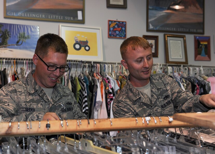 U.S. Air Force Staff Sgts. Jarod Seder and Christopher Horton, 23d Maintenance Group quality assurance inspectors, neatly arrange clothes donated to the Airman’s Attic at Moody Air Force Base, Ga., May 7, 2013. Seder and Horton frequently volunteer at the Airman’s Attic, a military support program that offers donated uniforms and household goods to Airmen E-5 and below at no cost. (U.S. Air Force photo by Senior Airman Eileen Meier/Released)
