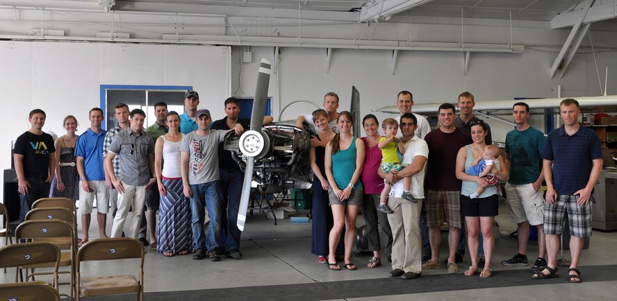 Close friends and members of the local Experimental Aircraft Association gathered to watch a biplane flyover and see Capt. Mark “Tyler” Voss’ unfinished aircraft May 10, 2013. Voss was one of the members killed in the recent KC-135 Stratotanker crash in Kyrgyzstan on May 3. (U.S. Air Force photo by 2nd Lt. Rachelle Smith) 