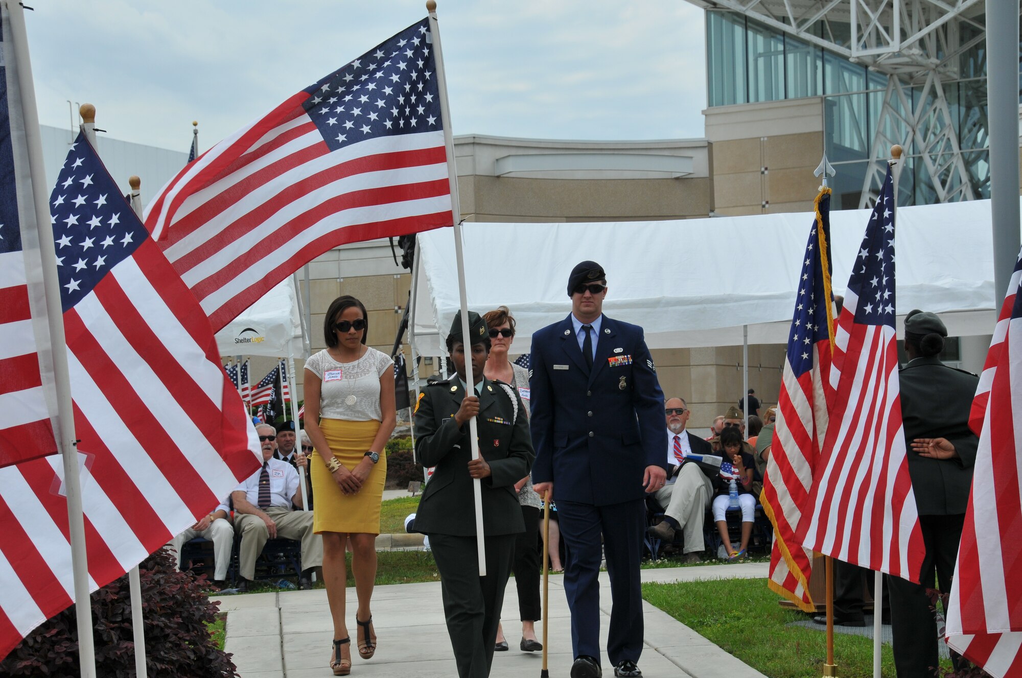 Senior Airman Aubrey Hand for the 440th Security Forces Squadron, accompanied by his wife Jasmine and mother Debbie, was honored at the 7th annual Field of Honor ceremony at the Airborne and Special Operations Museum, Fayetteville, N.C., May 11, 2013.  While on a route and culvert clearance mission, an improvised explosive device was detonated under his vehicle.  Despite his injuries, Hand provided assistance to others in the vehicle, checked for secondary devices and helped pull the gunner from the vehicle.  Almost 1,000 flags stand in the field in front of the museum, each flag honors someone who is currently serving, has served, or made the ultimate sacrifice for our nation.    (U.S. Air Force photo by Adam Luther, 440 AW/PA)
