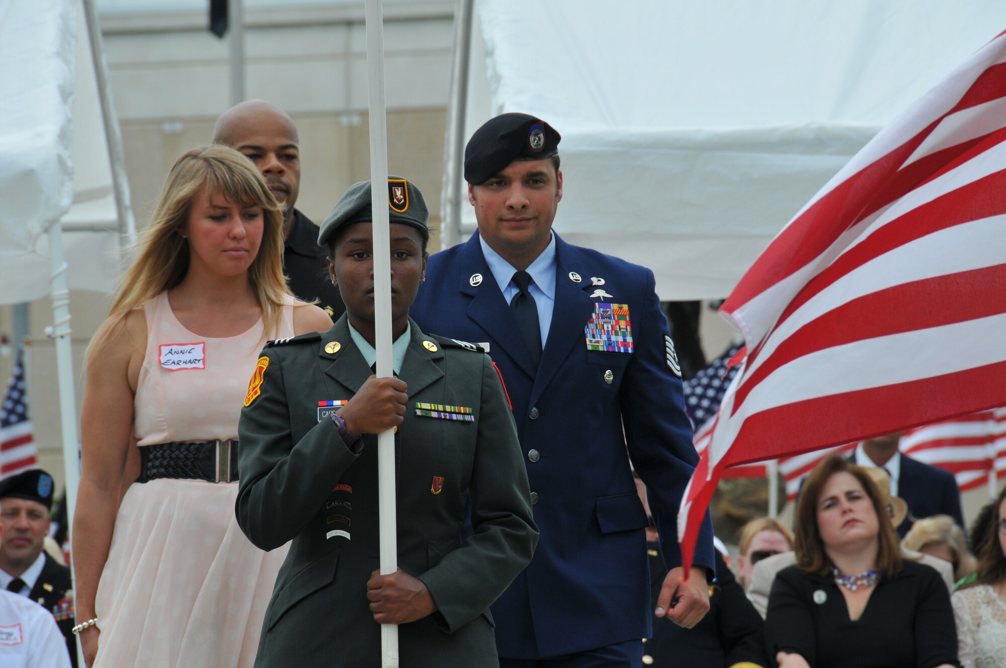 Tech. Sgt.  George Earhart from the 21st Special Tactics Squadron, accompanied by his wife Annie, was honored at the 7th annual Field of Honor ceremony at the Airborne and Special Operations Museum, Fayetteville, N.C., May 11, 2013.  Earhart was recognized for his actions while deployed to Afghanistan as a Tactical Air Control Party Craftsman attached to an Army Special Forces team.  Earhart rushed through a barrage of enemy fire to provide life saving medical treatment to his team leader. He subsequently controlled a medical evacuation and directed multiple air strikes which ended the enemy attack.  For his heroic actions he was awarded the Bronze Star with Valor.  Almost 1,000 flags stand in the field in front of the museum, each flag honors someone who is currently serving, has served, or made the ultimate sacrifice for our nation.    (U.S. Air Force photo by Adam Luther, 440 AW/PA)