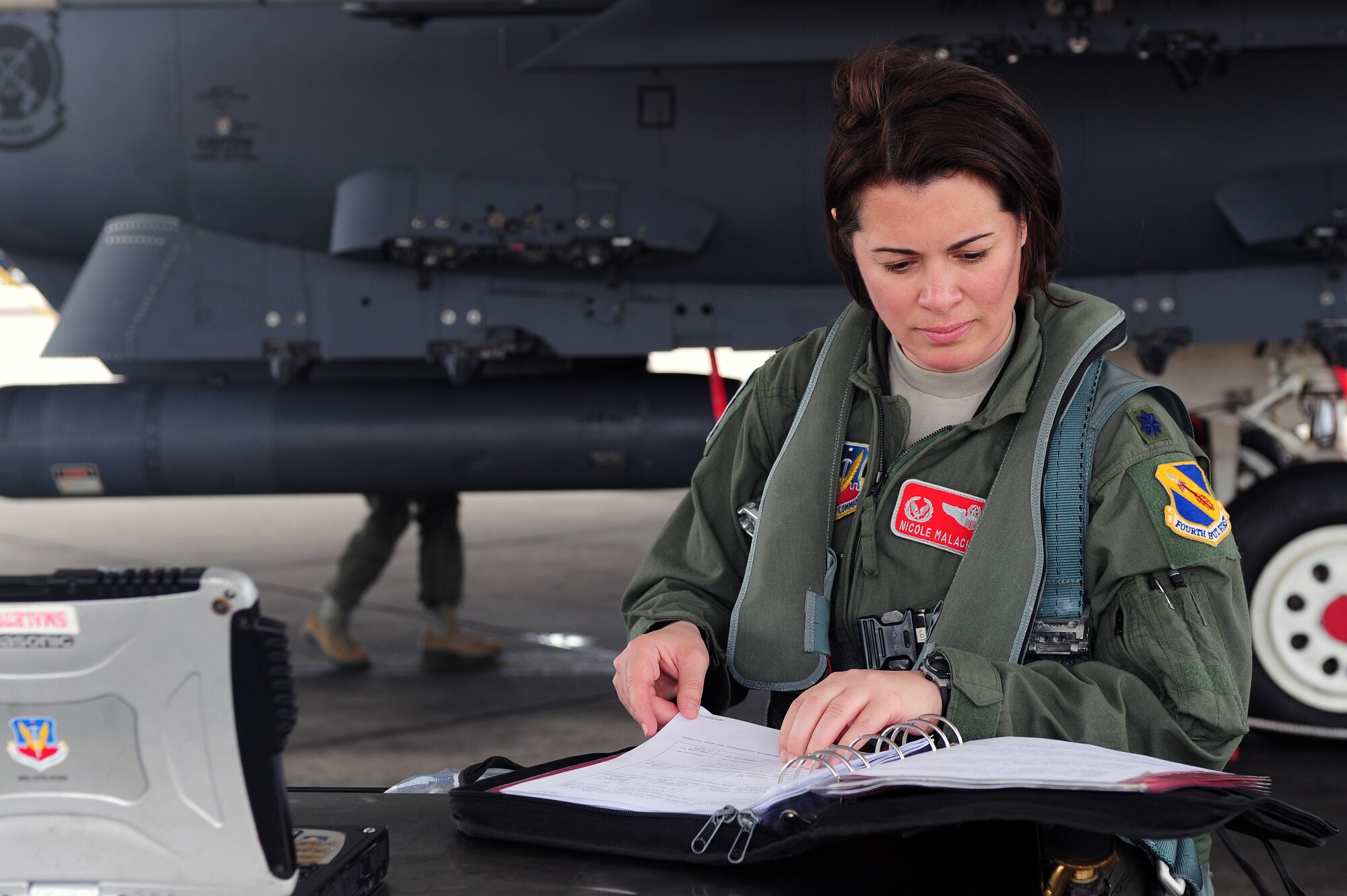 U.S. Air Force Lt. Col. Nicole Malachowski, 333rd Fighter Squadron commander, reviews aircraft logs during a pre-flight inspection on Seymour Johnson Air Force Base, N.C., May 8, 2013. Aircrew members review logs prior to flying to ensure the aircraft is ready for flight. (U.S. Air Force photo by Airman 1st Class John Nieves Camacho/Released)
