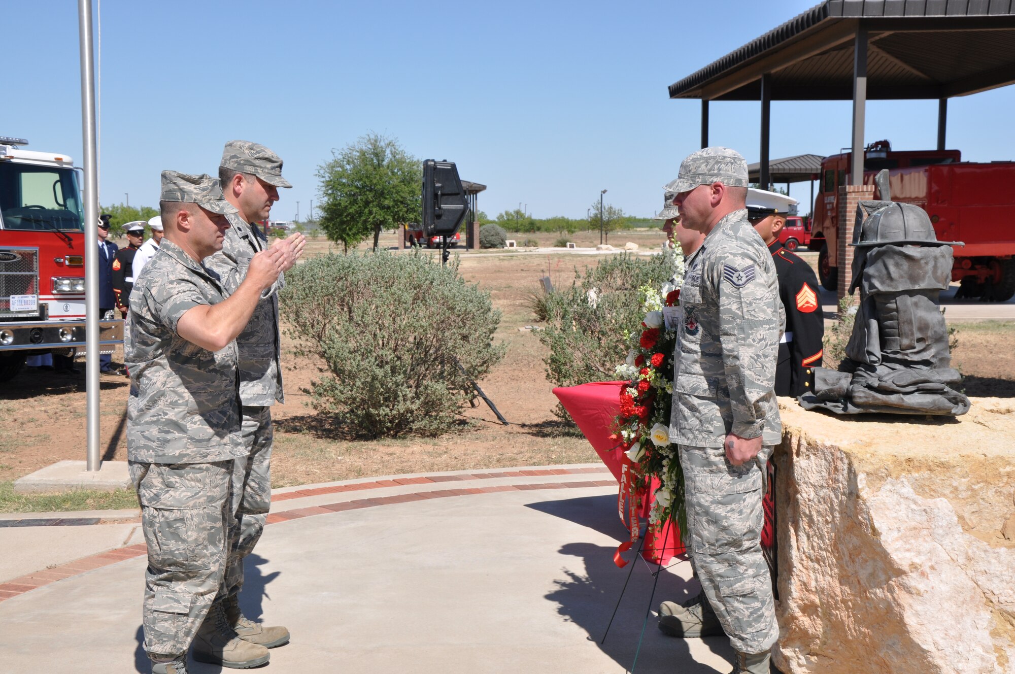 GOODFELLOW AIR FORCE BASE, Texas – Col. Mark Damiano, 17th Training Wing Commander, and Lt. Col. Derek Ferland, 312th Training Squadron Commander, salute a wreath at the firefighter memorial here, May 3. The wreath honored Defense Department firefighters who gave their lives protecting others. (U.S. Air Force photo/ Airman 1st Class Joshua Edwards)