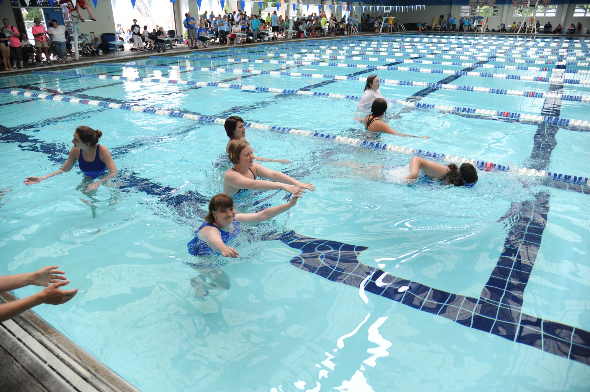 Assisted by lifeguards, athletes compete in the 15-meter walk at the Special Olympics Mississippi Summer Games on May 11, 2013, at the Biloxi natatorium.  More than 900 athletes and 3,000 volunteers worked together to hold competitions throughout the day.  This is the 27th year Keesler has hosted the state Special Olympics.   (U.S. Air Force photo by Kemberly Groue)
