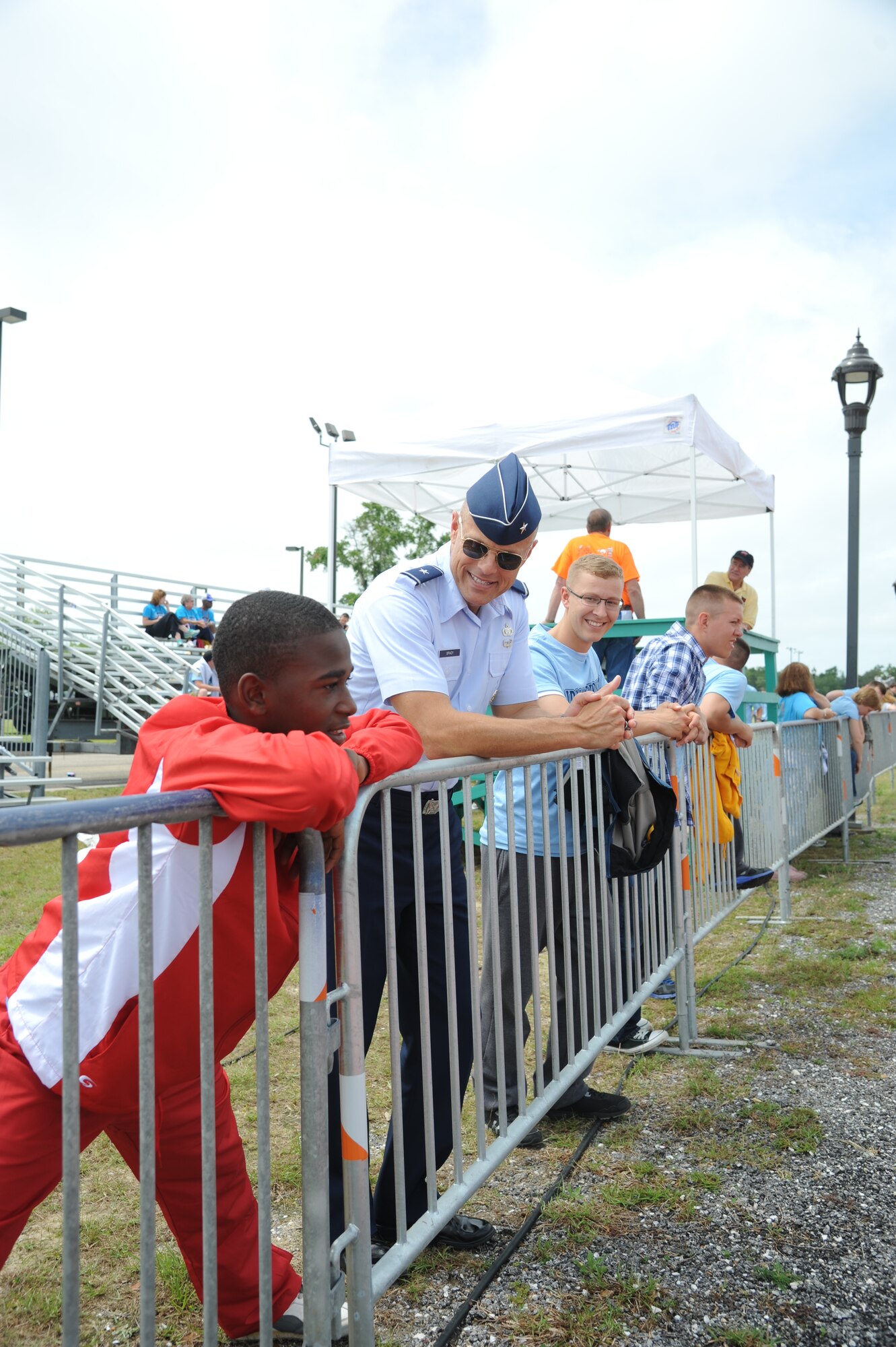 Devonta, athlete, watch the track events with Brig. Gen. Brad Spacy, 81st Training Wing commander, at the Special Olympics Mississippi Summer Games on May 11, 2013, at Keesler Air Force Base, Miss.  More than 900 athletes and 3,000 volunteers worked together to hold competitions throughout the day.  This is the 27th year Keesler has hosted the state Special Olympics.   (U.S. Air Force photo by Kemberly Groue)