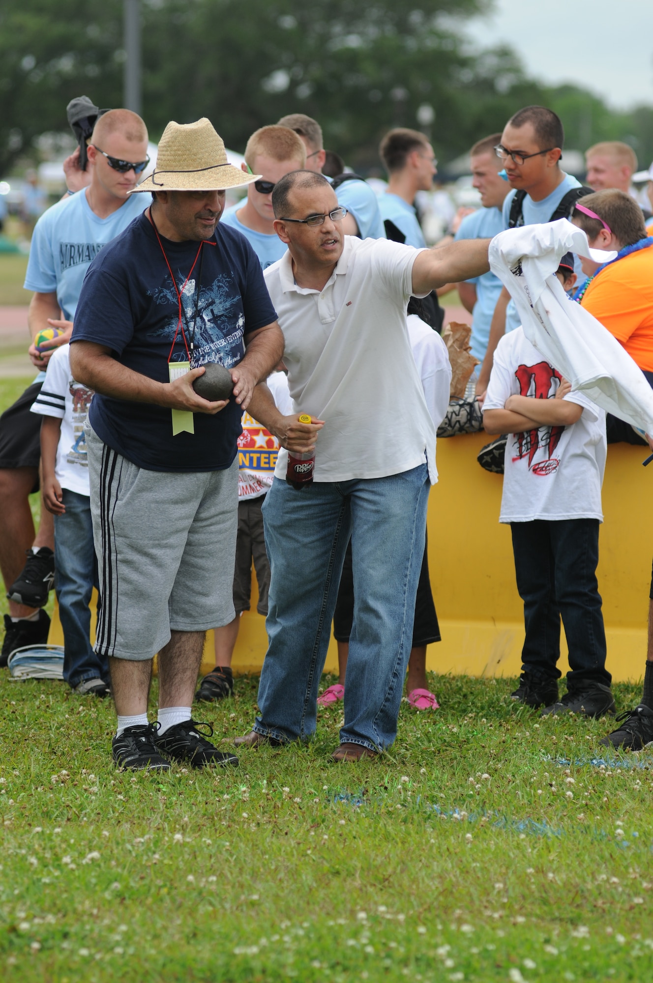 Carl Blankenship, athlete, receives direction from Jose Fuertes, 81st Communications Squadron and volunteer, during the shot put competition at the Special Olympics Mississippi Summer Games on May 11, 2013, at Keesler Air Force Base, Miss.  More than 900 athletes and 3,000 volunteers worked together to hold competitions throughout the day.  This is the 27th year Keesler has hosted the state Special Olympics.   (U.S. Air Force photo by Kemberly Groue)