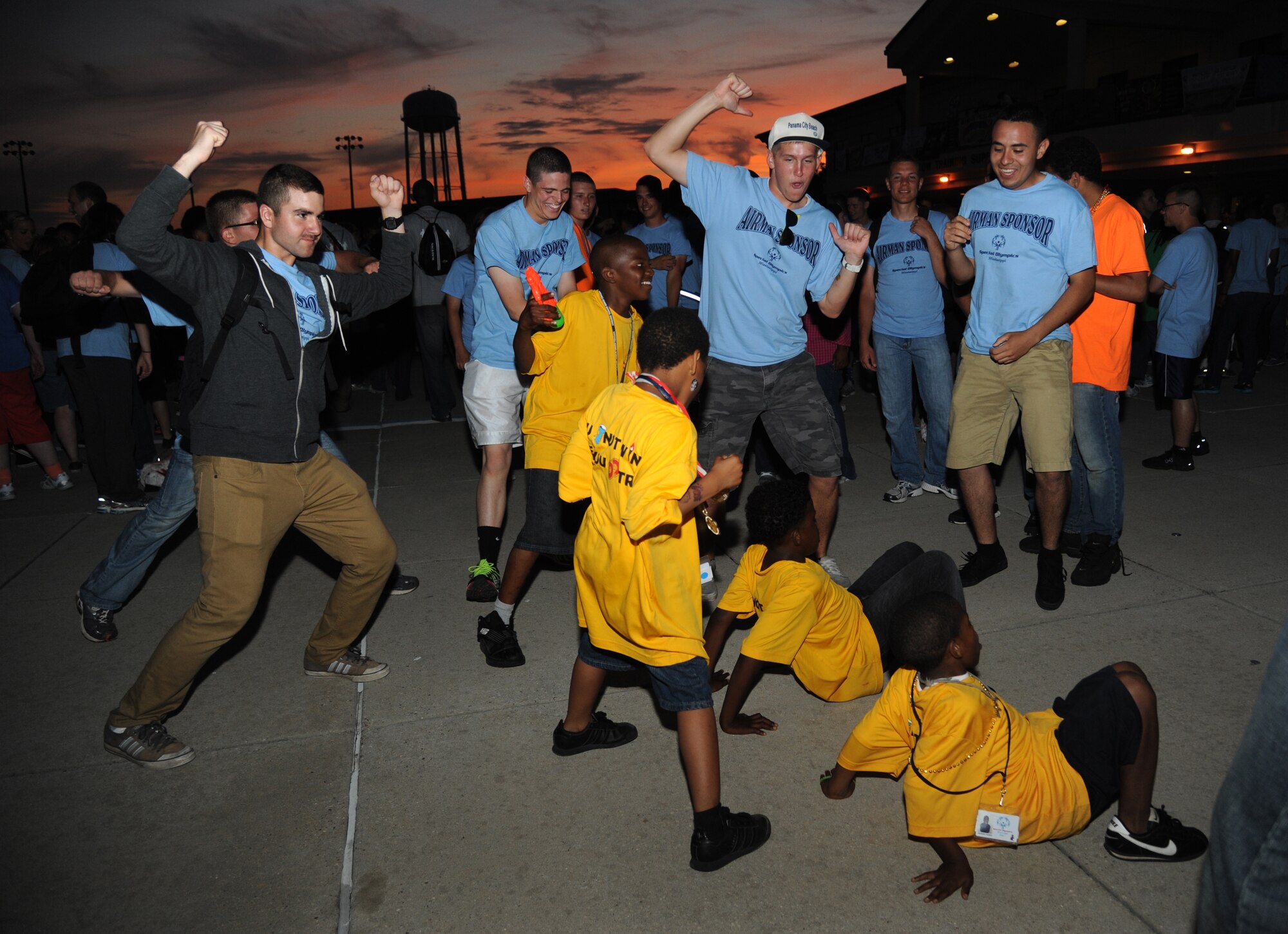 Airman Lucas Blackburn, and Airmen 1st Class Marcus Allen, Cody Darling and Sal Alvarez, 338th Training Squadron, dance with athletes at closing ceremonies during the Special Olympics Mississippi Summer Games on May 11, 2013, at the Triangle Fitness Center, Keesler Air Force Base, Miss.  More than 900 athletes and 3,000 volunteers worked together to hold competitions throughout the day.  This is the 27th year Keesler has hosted the state Special Olympics.   (U.S. Air Force photo by Kemberly Groue)