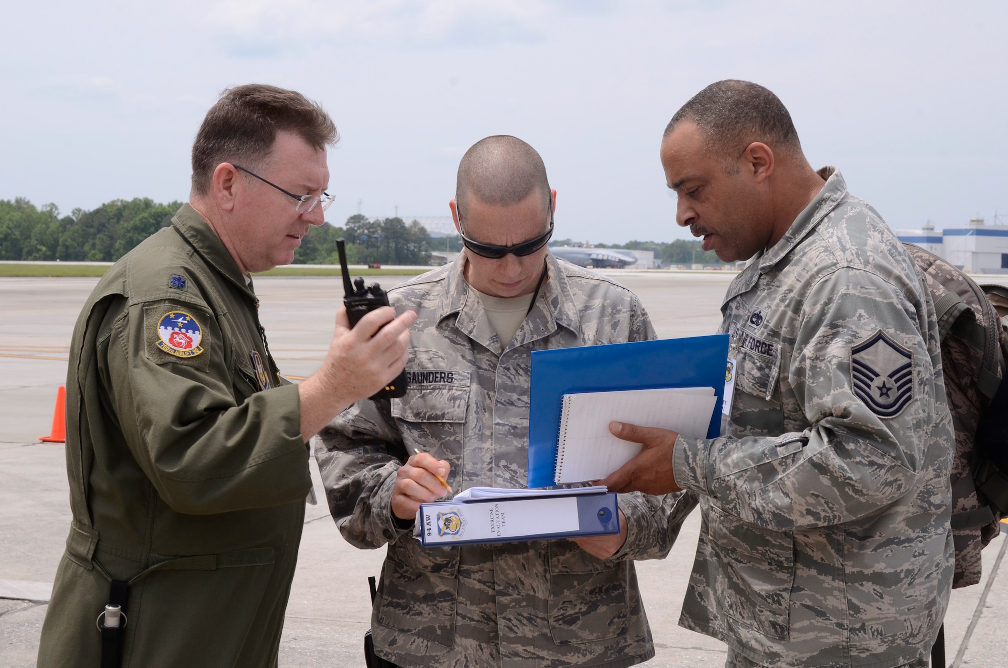 Exercise evaluation team discuss details of a major accident response exercise (MARE) simulating an incident where an aircraft refueling truck collided with a parked C-130 Hercules was conducted on Dobbins Air Reserve Base, Ga.  May 10. The scenario evaluated the response time and operating procedures of first responders, and explosive ordnance personnel from the 94th Airlift Wing. (U.S. Air Force photo/Don Peek)