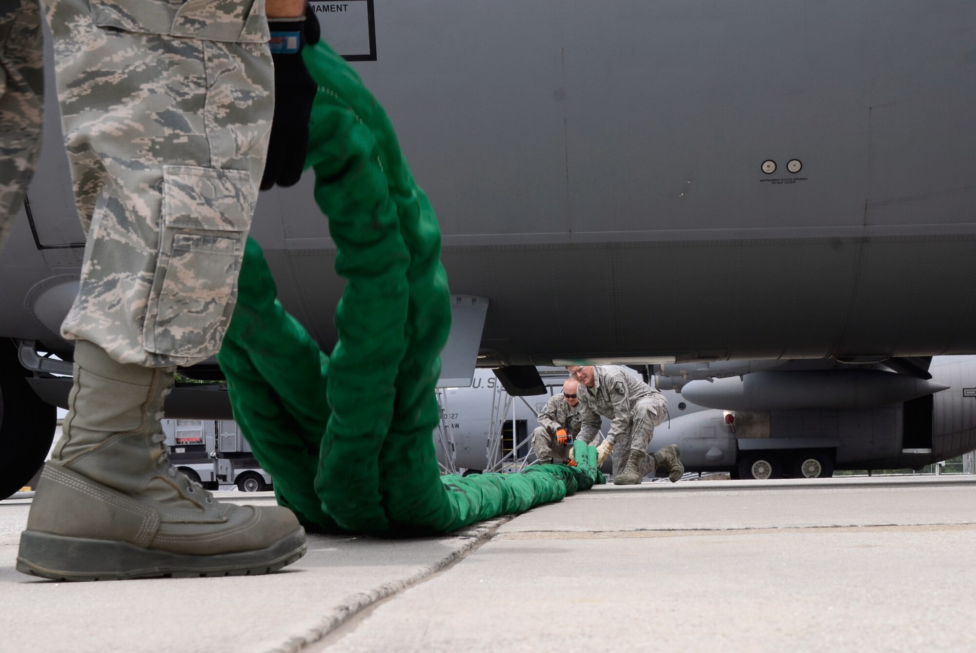 Members of the Crash, Damaged, and Disabled Aircraft Recovery (CDDAR) Team from the 94th Maintenance Squadron scramble to assess, recover and repair simulated damage to the nose area and collapsed nose landing gear of a C-130 Hercules staged collision by a refueling truck during an exercise scenario on Dobbins Air Reserve Base, Ga., May 10. The exercise was part of a Consolidated Unit Inspection (CUI) conducted on Dobbins. (U.S. Air Force photo/Don Peek)