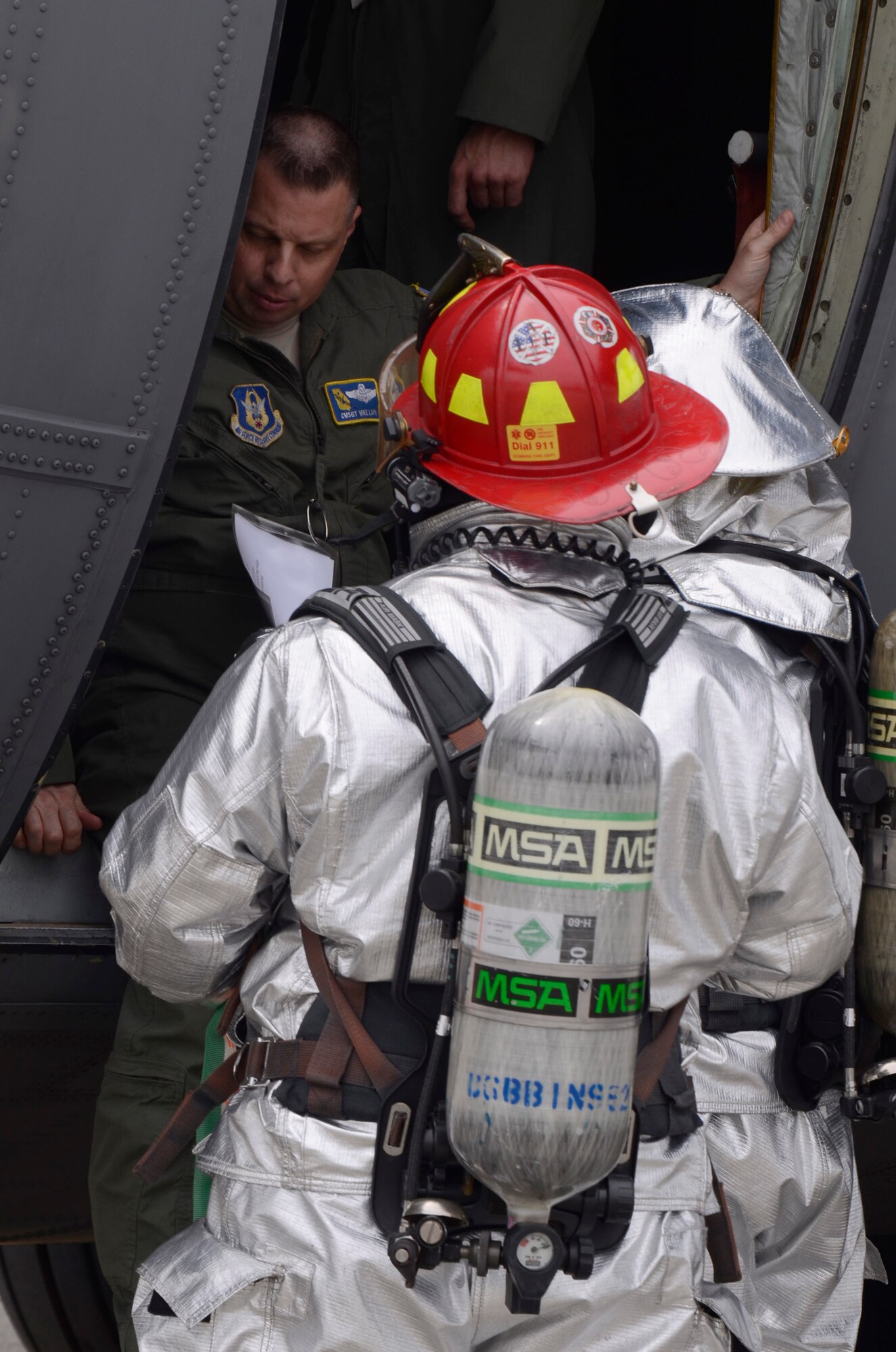 Member of the Dobbins Fire Department evacuates and assists simulated injured crew members while responding to a realistic scenario involving the collision of an aircraft refueling truck and a C-130 Hercules during an exercise held on Dobbins Air Reserve Base, Ga. May 10. (U.S. Air Force photo/Don Peek)
